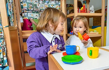 Mädchen spielen in der Puppenküche